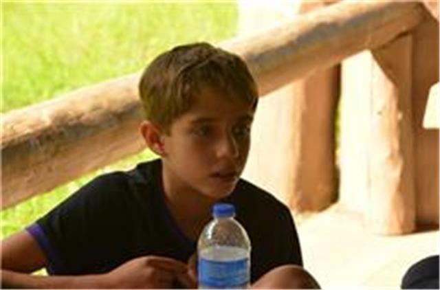 Boy sitting at the campsite