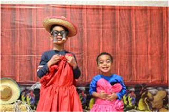Children posing in the photo booth area in costume
